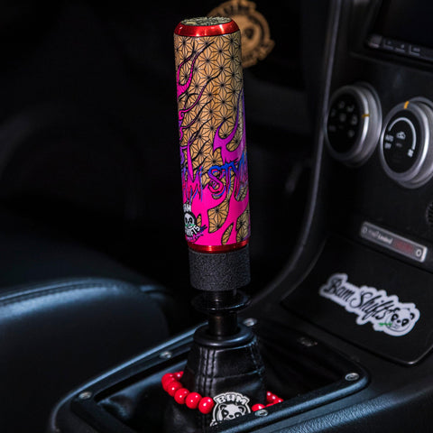 Two shift knobs of different sizes next to each other. Anime Themed. 
